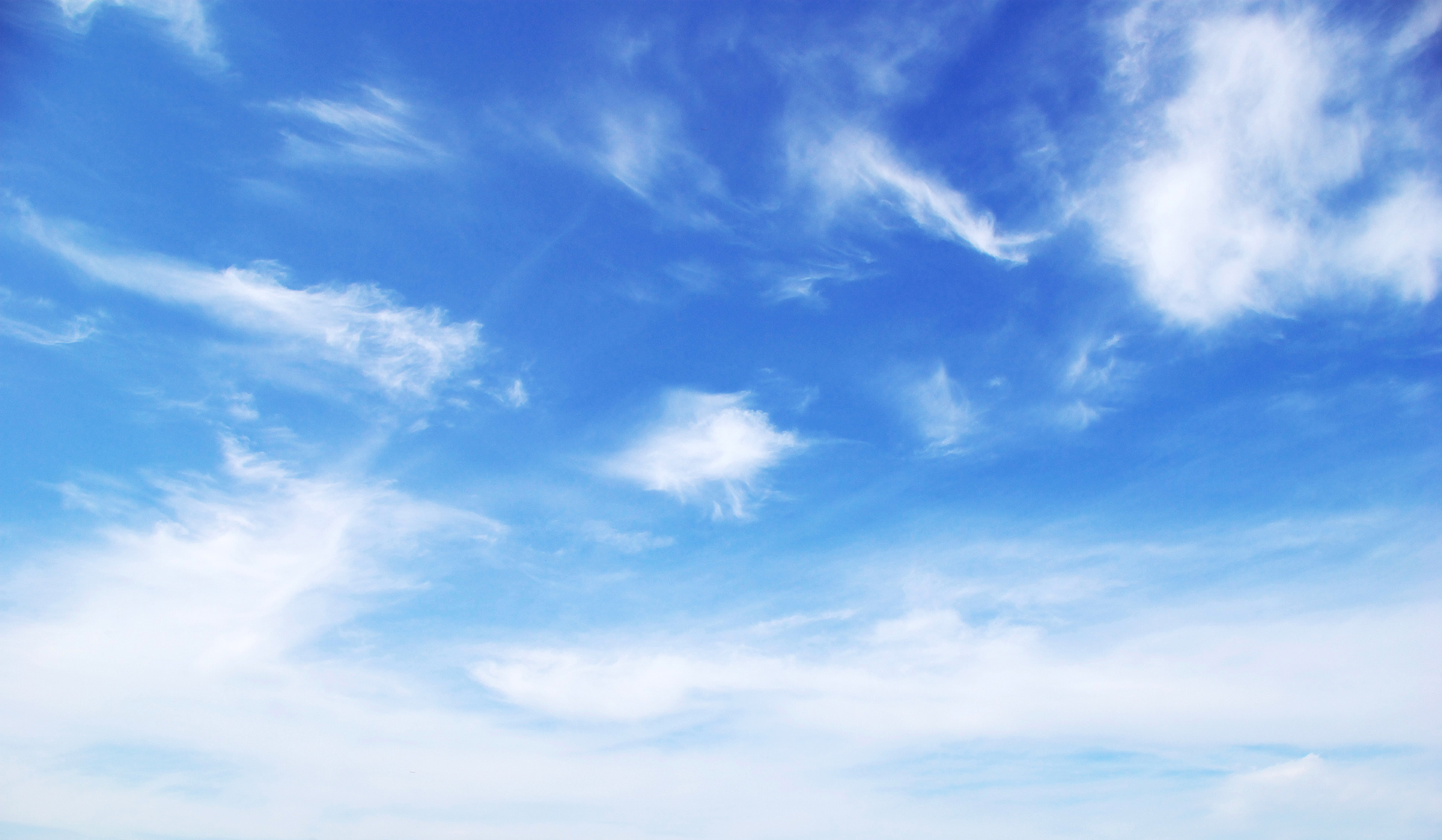 Blue sky background with tiny clouds..