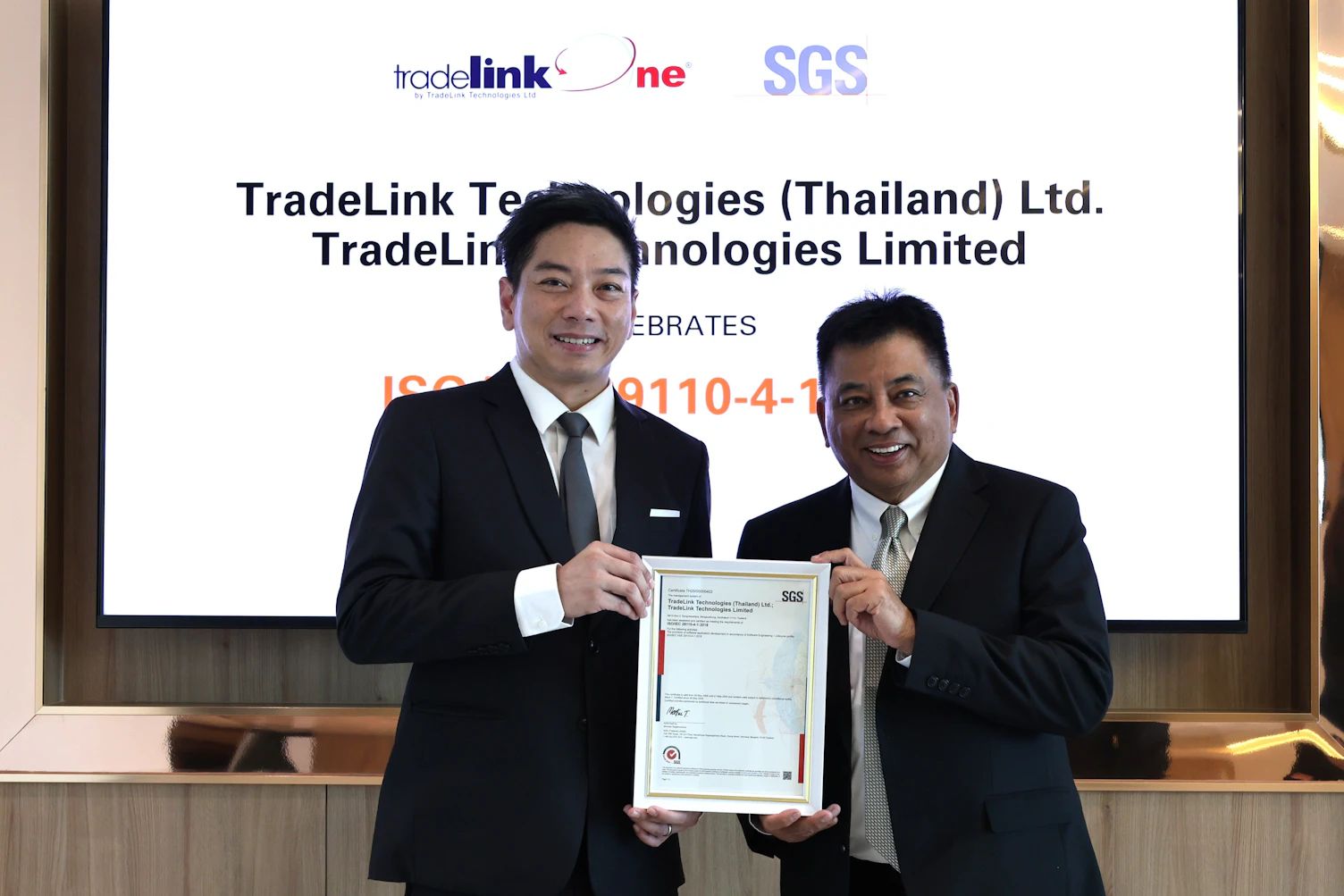 SGS representative presenting ISO 29110 certificate to TradeLink Technologies executive team