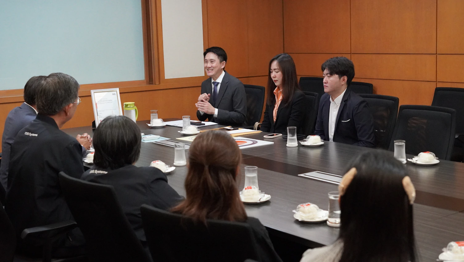 SGS and CDGS executives discussing information security management practices in line with ISO/IEC 27001 standard