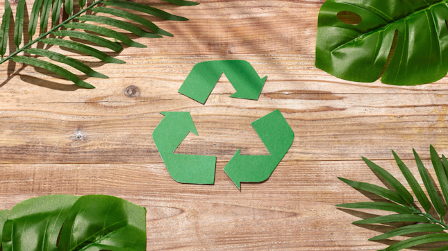 Recycling Symbol Surrounded by Tropical Leaves
