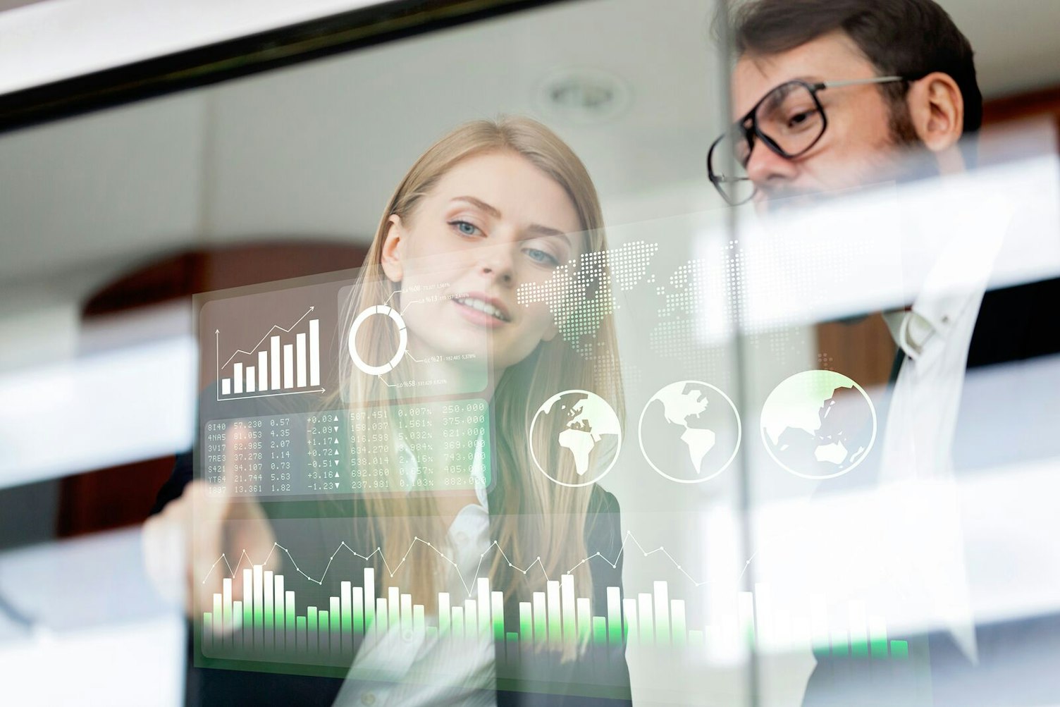 Business colleagues discussing financial data on screen