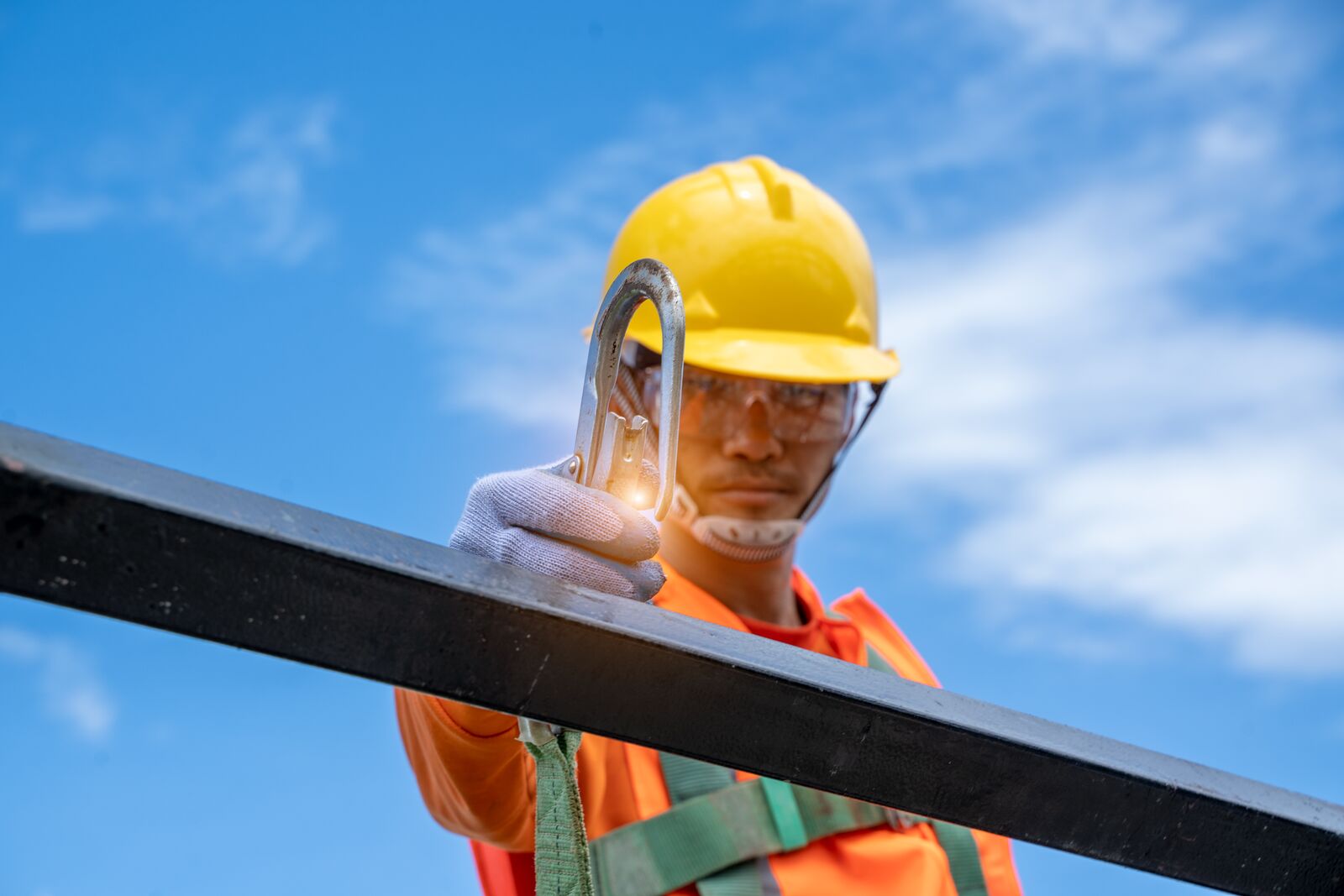 Construction Worker Connecting his Safety Harness
