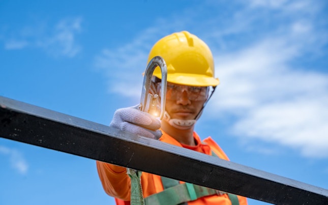 Construction Worker Connecting his Safety Harness