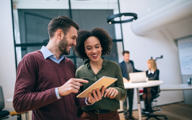 Co-workers Looking at a Digital Tablet