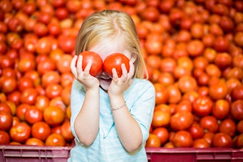 Girl Playing with Tomatoes