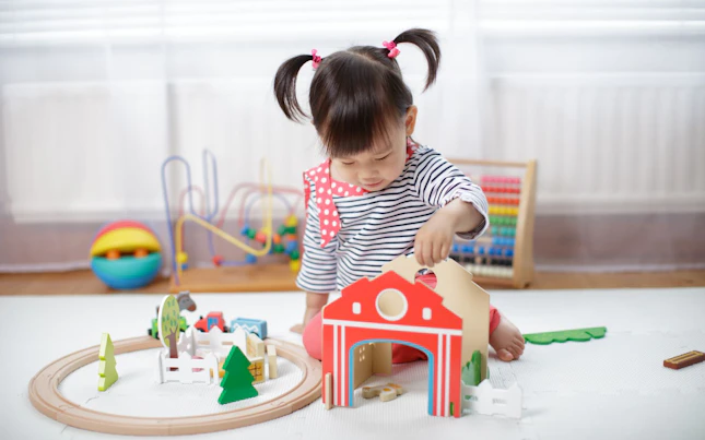 Girl Playing with Wooden Toys