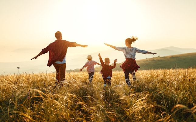 Happy Family Running in a Field