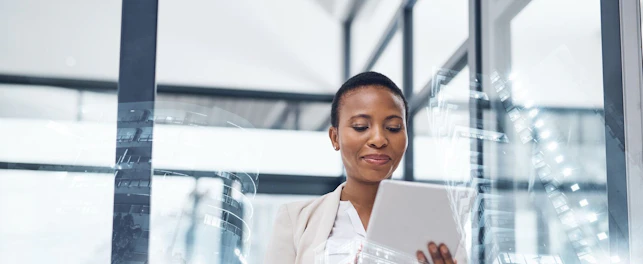 Lady Holding Tablet in Meeting Room in Front of Window