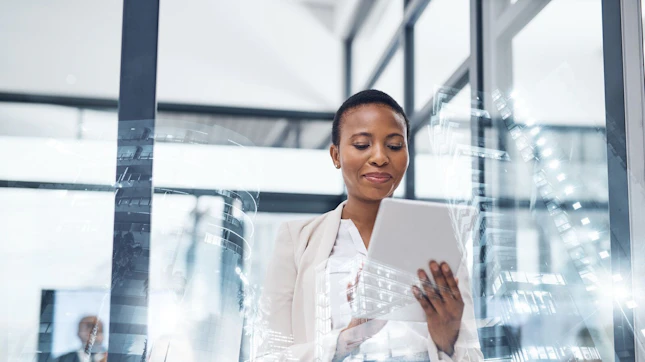 Lady Holding Tablet in Meeting Room in Front of Window