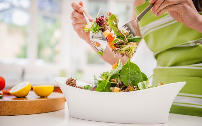 Lady Tossing Fresh Salad Assortment