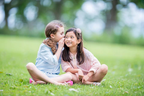 Little girls Sitting on the Grass