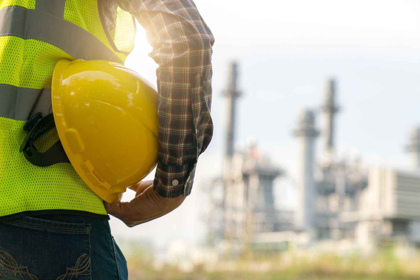 Mid Section of a Worker Holding his Safety Helmet