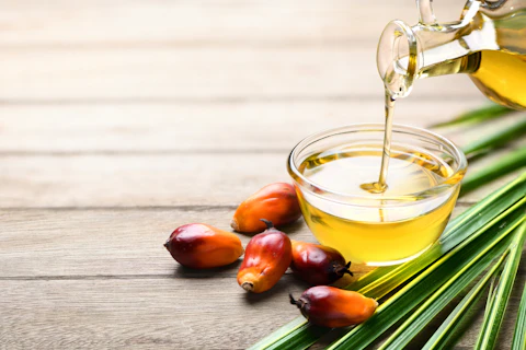 palm oil being poured into a cup