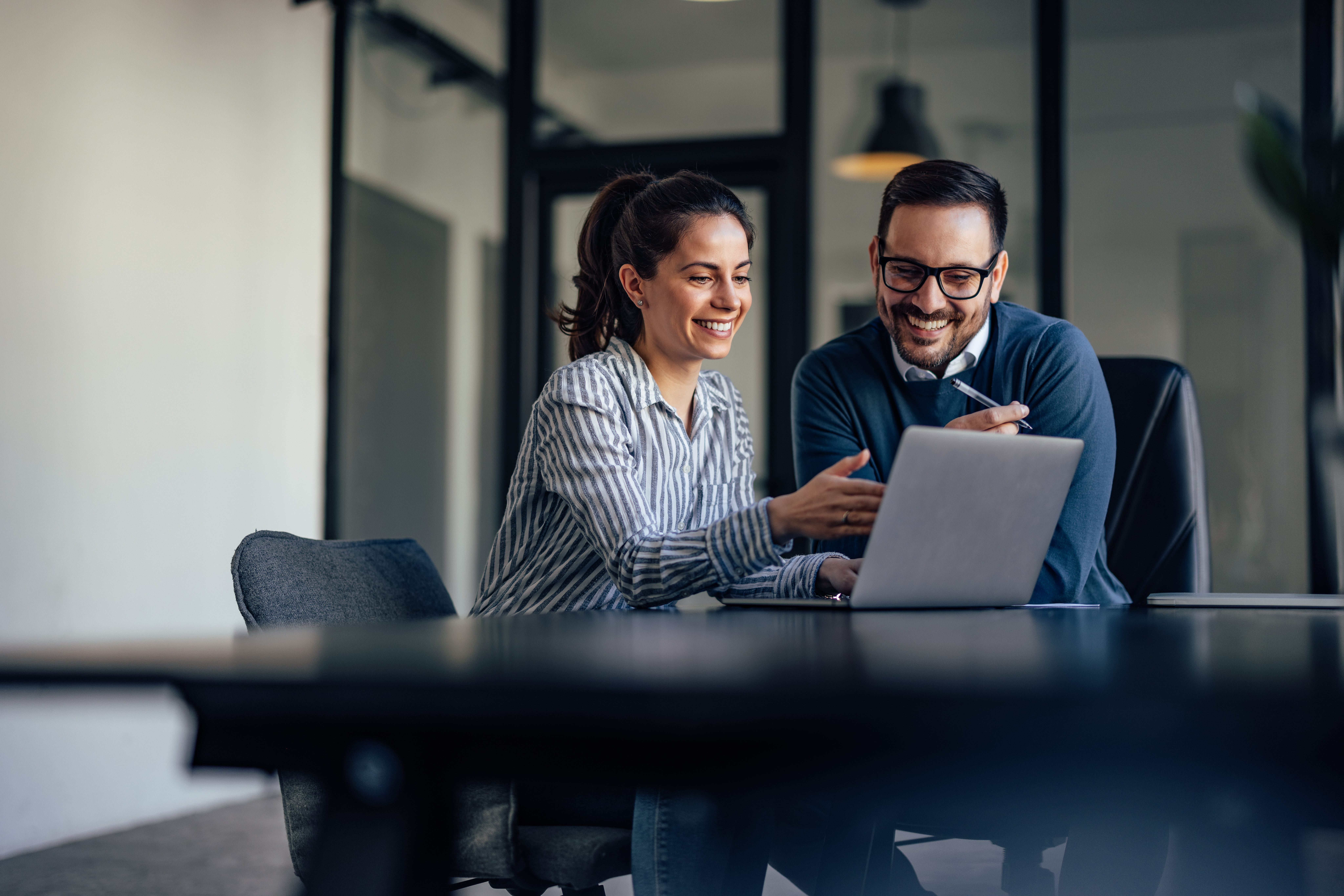 Portrait of Two Business Colleagues Looking at Something Online
