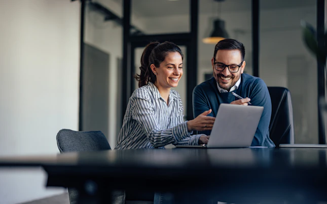 Portrait of Two Business Colleagues Looking at Something Online