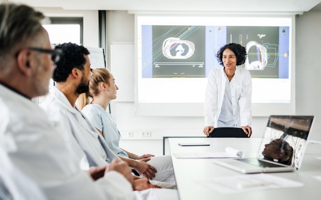 Scientist Explaining Protocol in Meeting to Colleagues