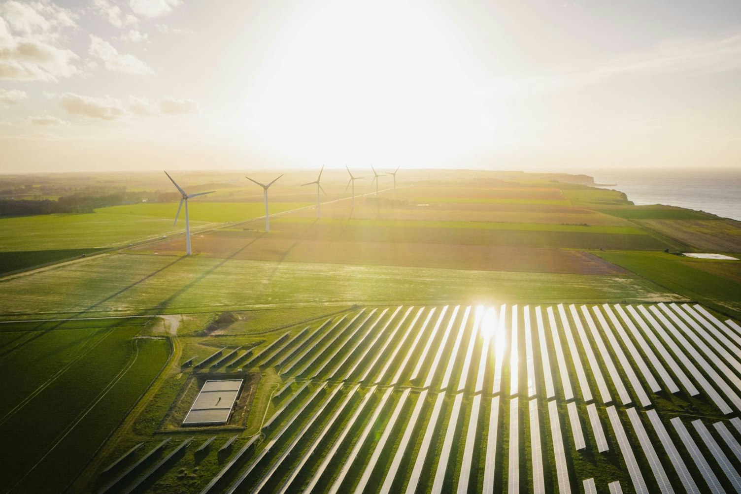 Wind Turbines and Solar Panels Farm in a Field