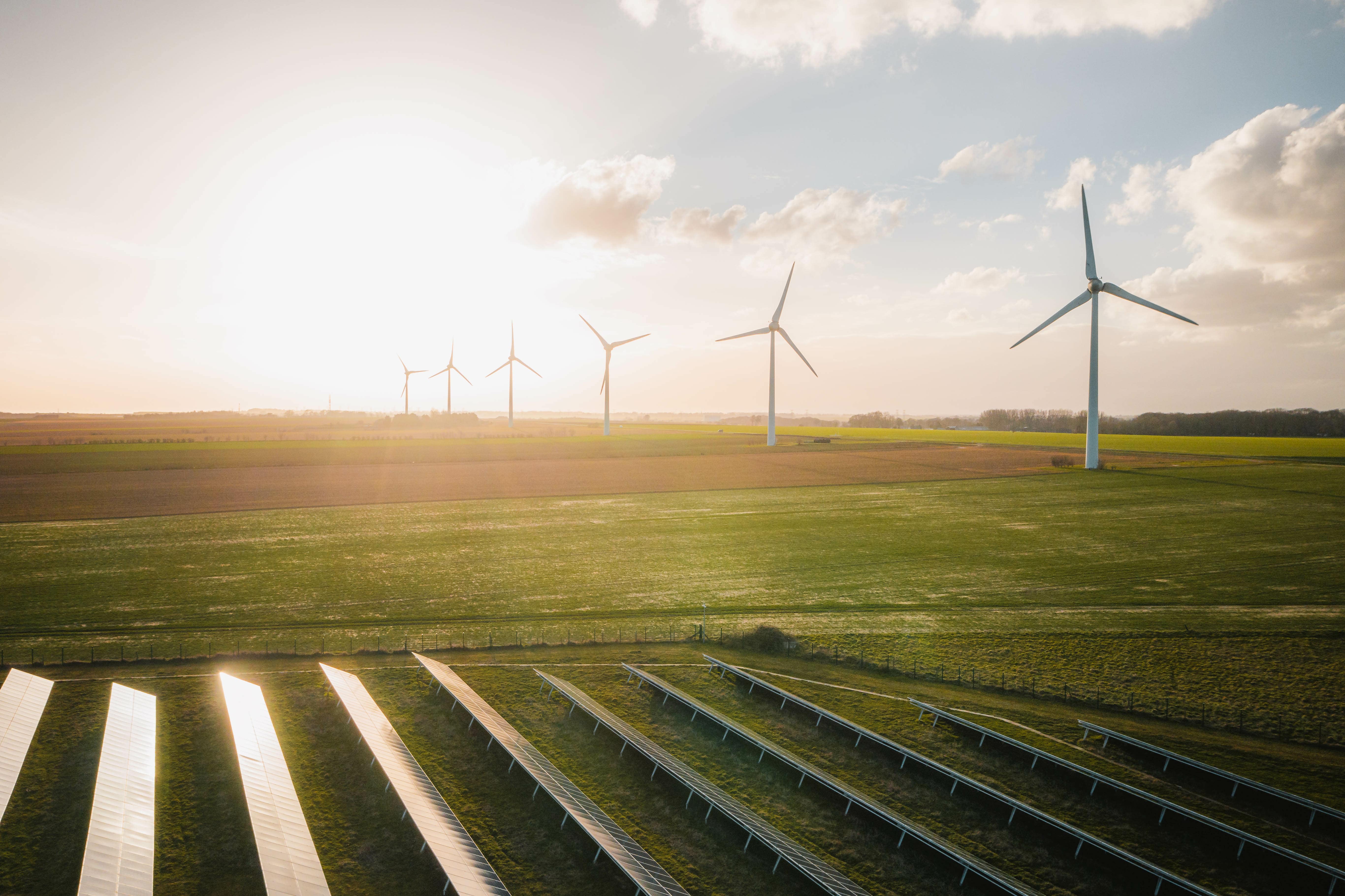Wind Turbines and Solar Panels Farm in a Field