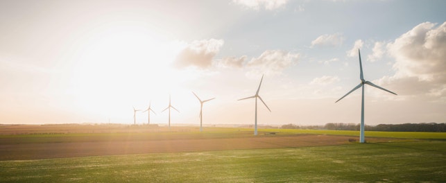 Wind Turbines and Solar Panels Farm in a Field