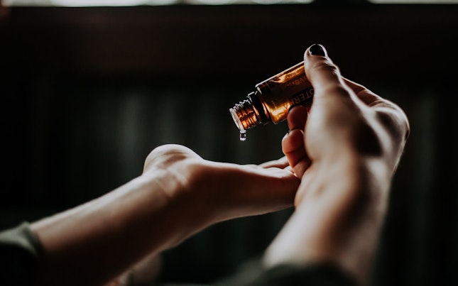 Woman Applying Essential Oil
