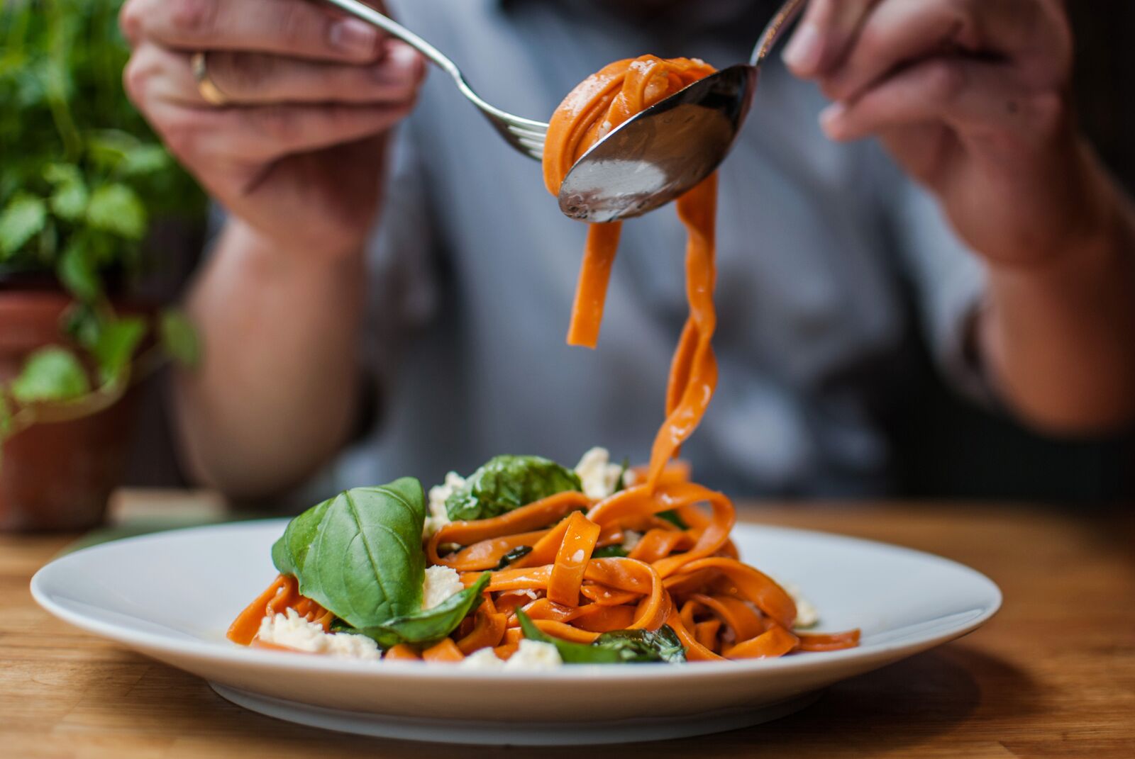 Woman Eating Pasta In A Restaurant