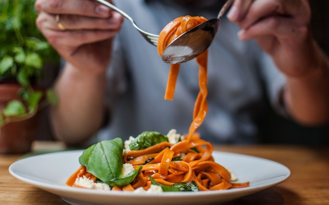 Woman Eating Pasta In A Restaurant
