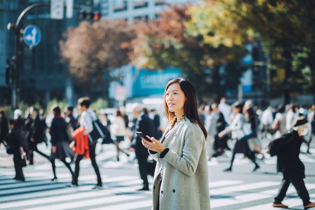 Woman Using her Smart Phone in the Street