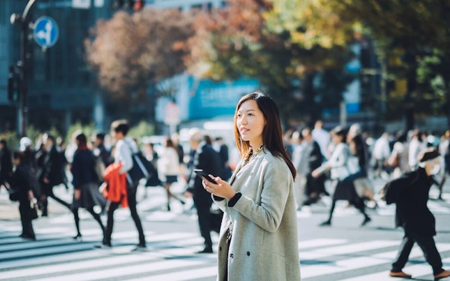 Woman Using her Smart Phone in the Street