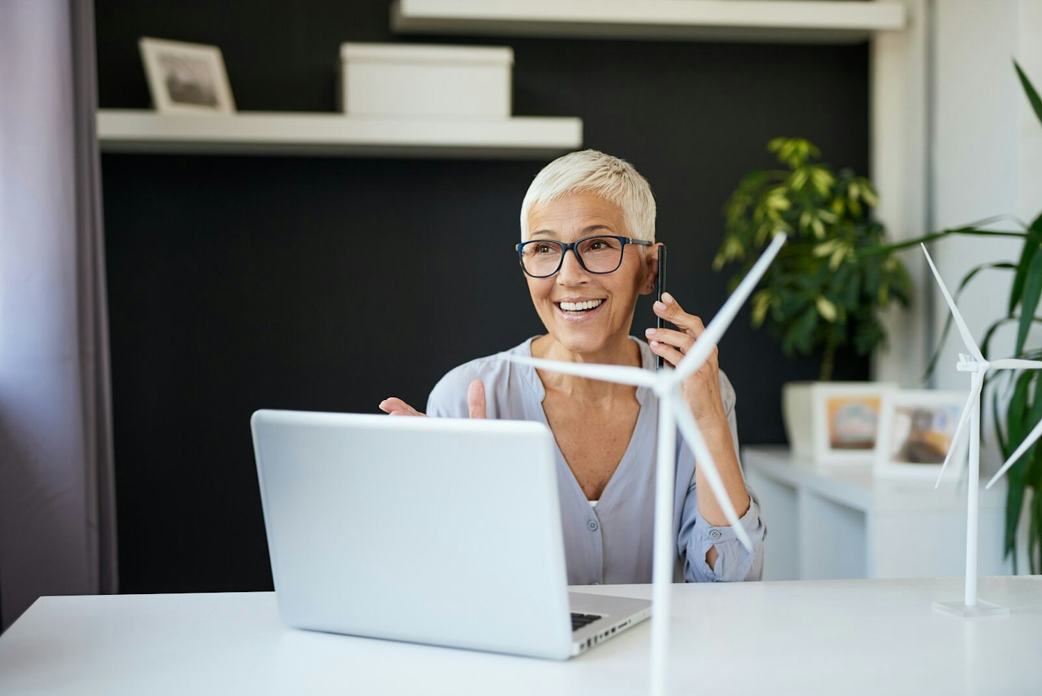 Woman Working at a Desk with Windmill Model