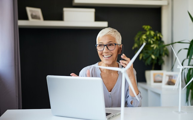 Woman Working at a Desk with Windmill Model
