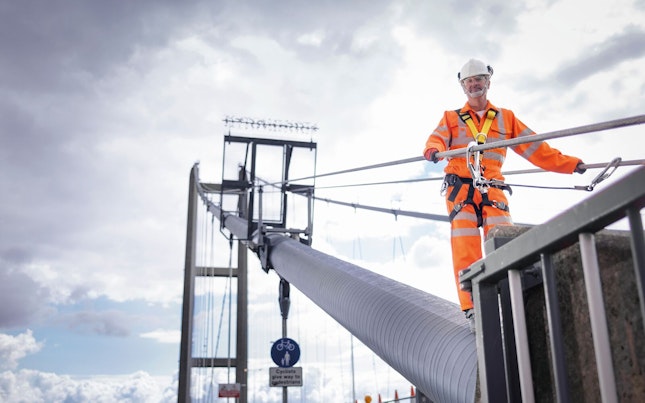Worker on Suspension Bridge