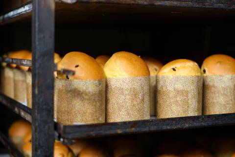 A rack of bread loaves with a paper wrapper