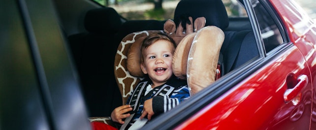 Adorable baby boy in safety car seat