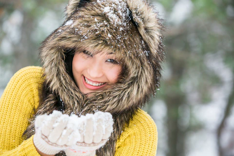 Asian girl in a cap from the skin of a wolf