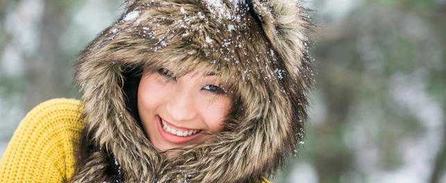 Asian girl in a cap from the skin of a wolf