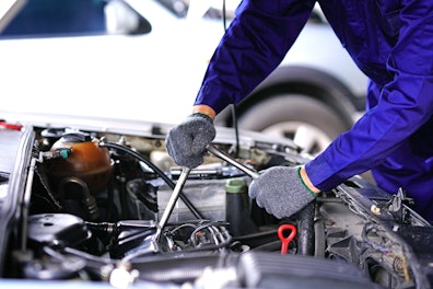 Auto Mechanic Using Repair Tools in a Garage