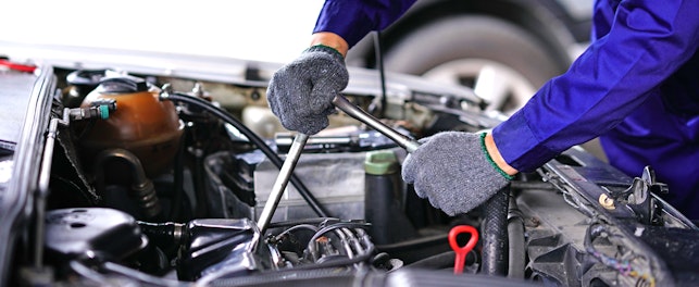 Auto Mechanic Using Repair Tools in a Garage