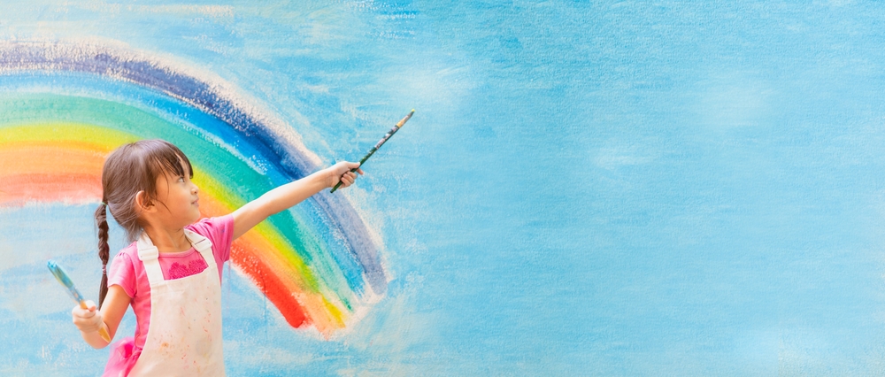 Banner of asian little girl is painting the colorful rainbow