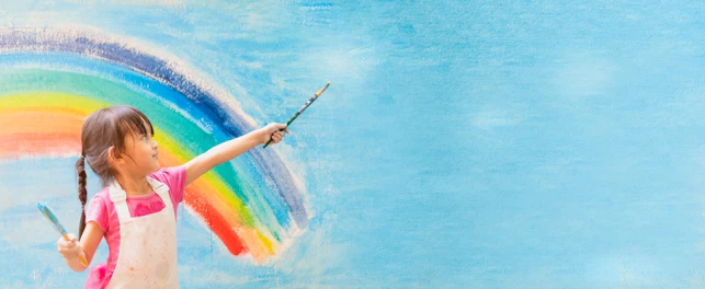 Banner of asian little girl is painting the colorful rainbow