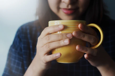 Beautiful Woman Drinking Lemon Ginger Tea in the Morning or Cold Season