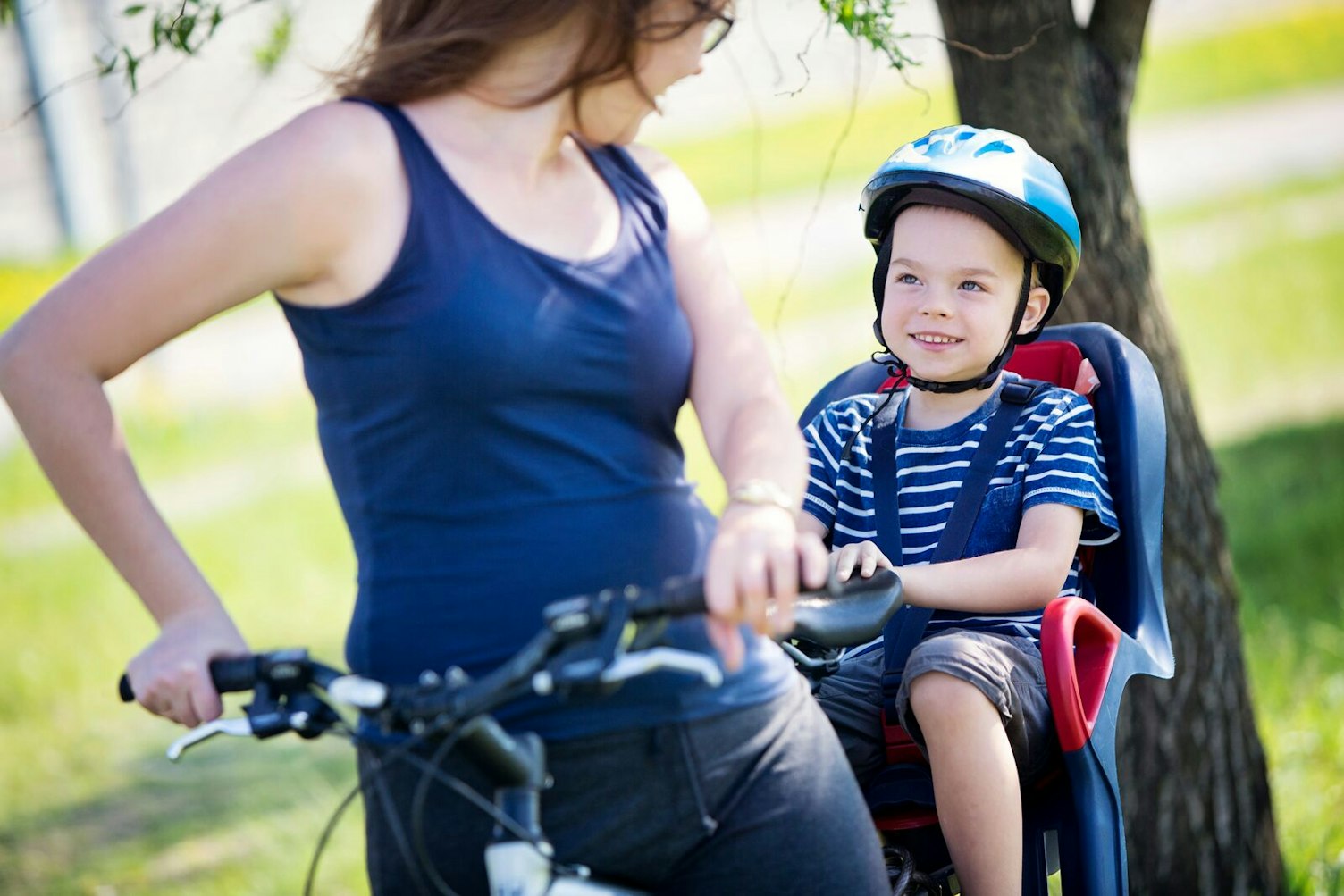 Boy Riding with his Mother on a Bicycle