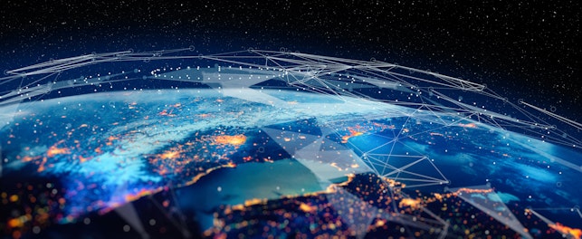 Earth from space with illuminated city lights and glowing network-like patterns overlaid, symbolizing global digital connectivity and data exchange