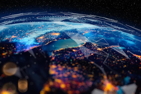 Earth from space with illuminated city lights and glowing network-like patterns overlaid, symbolizing global digital connectivity and data exchange