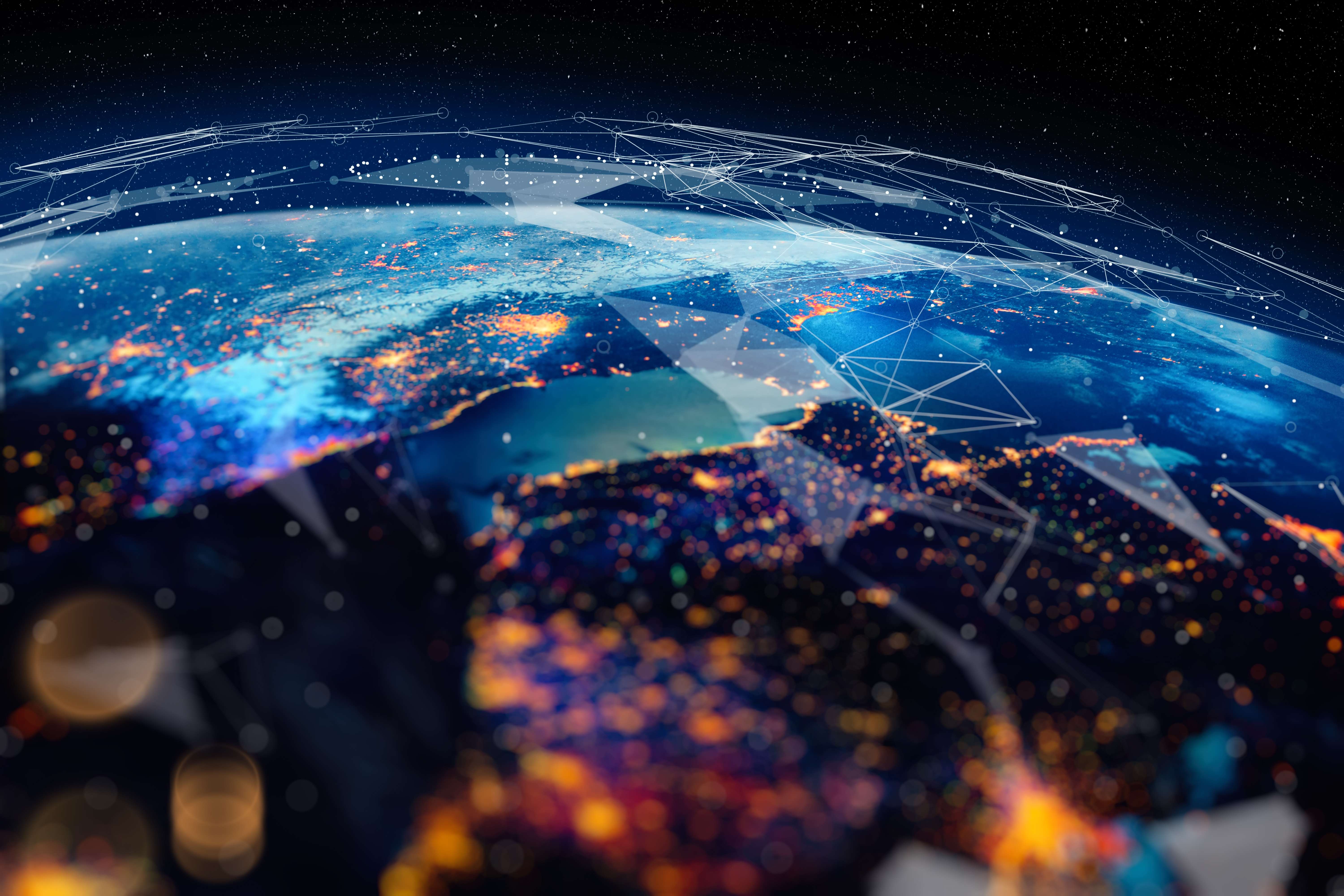 Earth from space with illuminated city lights and glowing network-like patterns overlaid, symbolizing global digital connectivity and data exchange