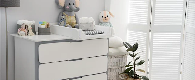 Changing tray and pad on chest of drawers in baby room
