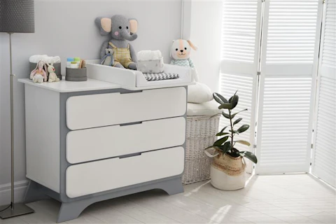 Changing tray and pad on chest of drawers in baby room