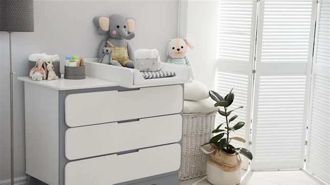Changing tray and pad on chest of drawers in baby room