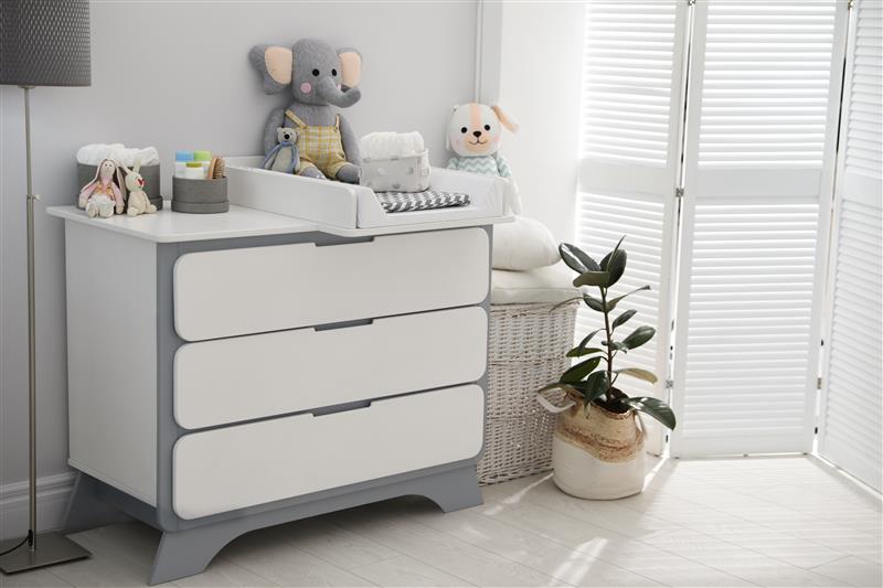 Changing tray and pad on chest of drawers in baby room