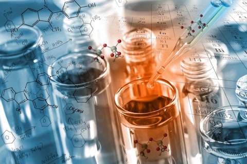 chemist dropping the clear reagent into test tube for reaction testing in chemical laboratory, with chemical equations and periodic table background.