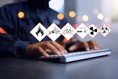 Close up of Man in Front of Computer with Hazard Warnings